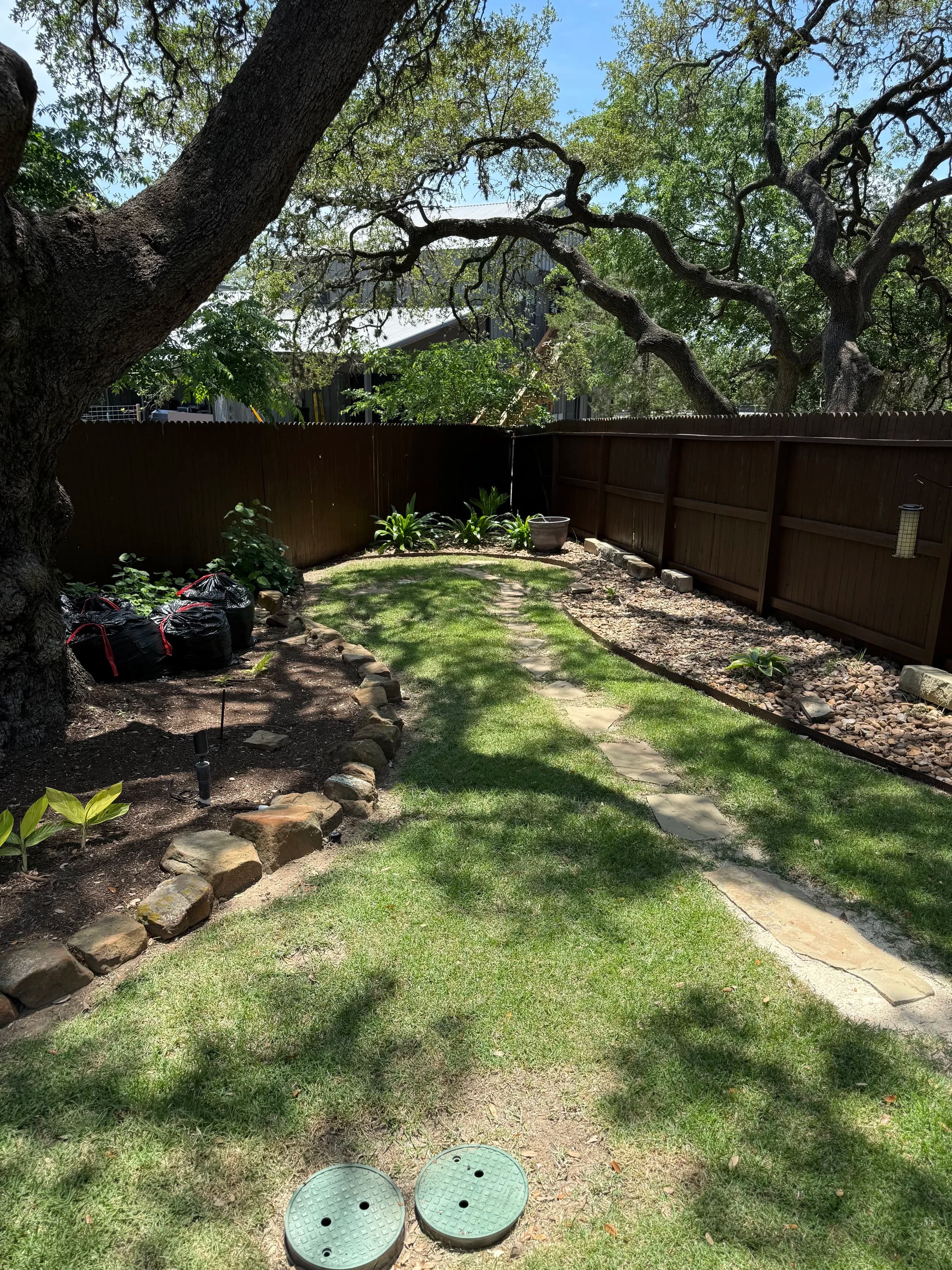 Stained fence in a backyard garden setting