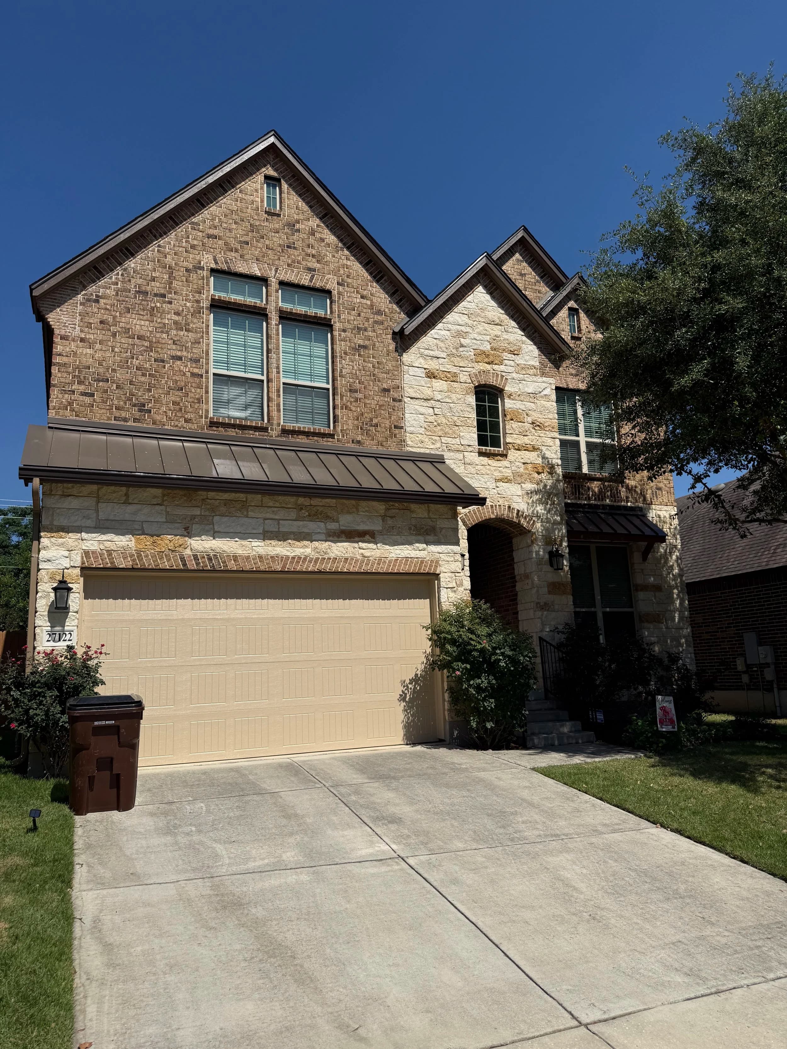 Exterior repaint on a stone and brick home